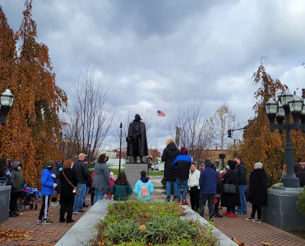 WVS tour participants stand on the Westfield Green downtown with while tour guide, Cindy Gaylord, speaks about local monuments and landmarks.