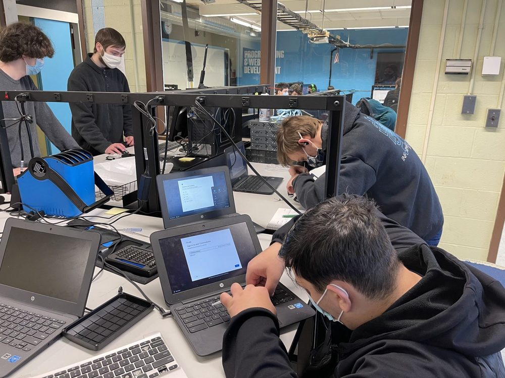 students working on chromebook repairs