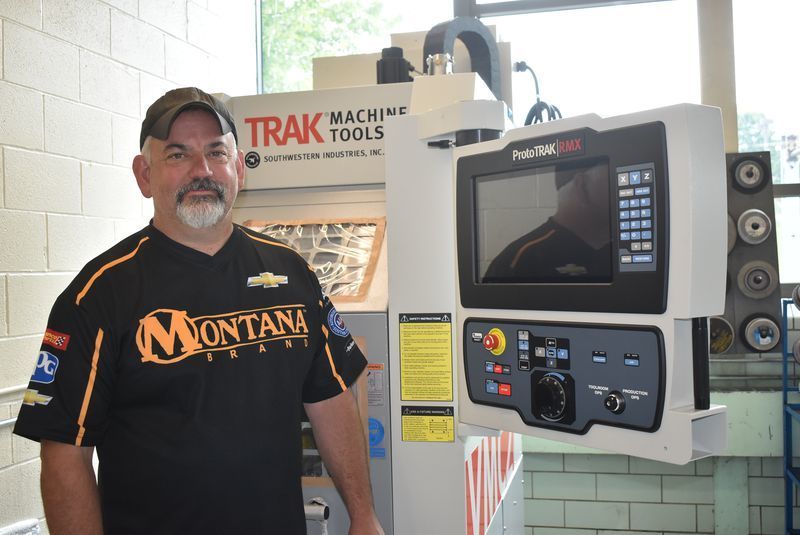 Mr. Nadeau in front of a new VMC2 Vertical Machining Center